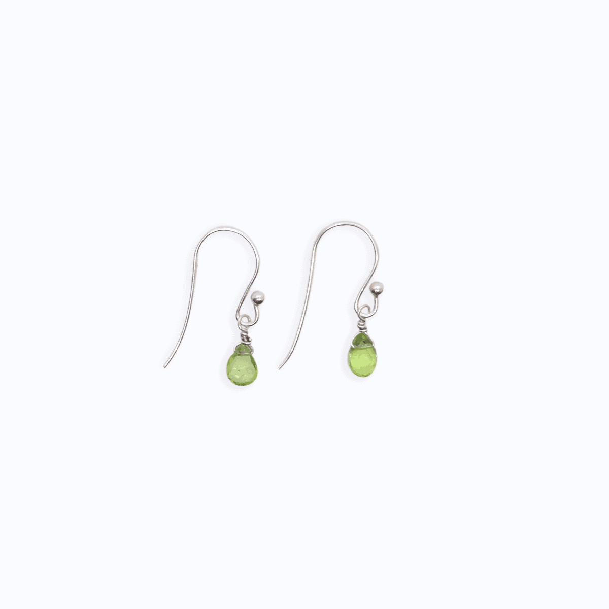 Flat lay view of Sterling Silver shepherd’s hook earring with Peridot drop on white background.