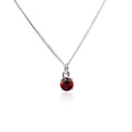Front view of the Garnet Pendant Sterling Silver necklace on a white background. The necklace features a 5mm round Garnet gemstone set in four claws on a 45cm curb chain.