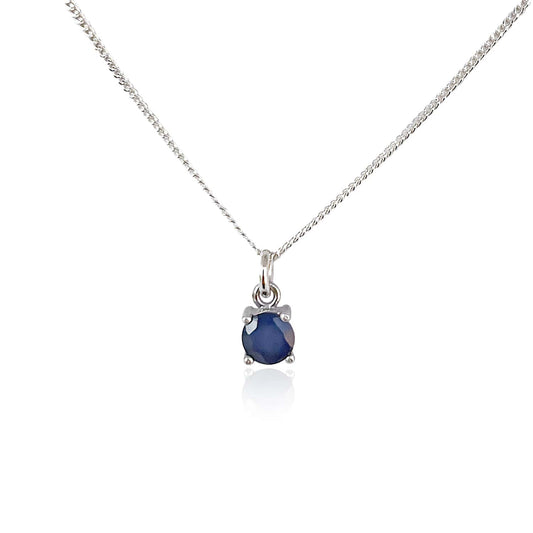 Front view of Sapphire Pendant necklace on white background. 5mm round Sapphire gemstone in four claws on 45cm curb chain.