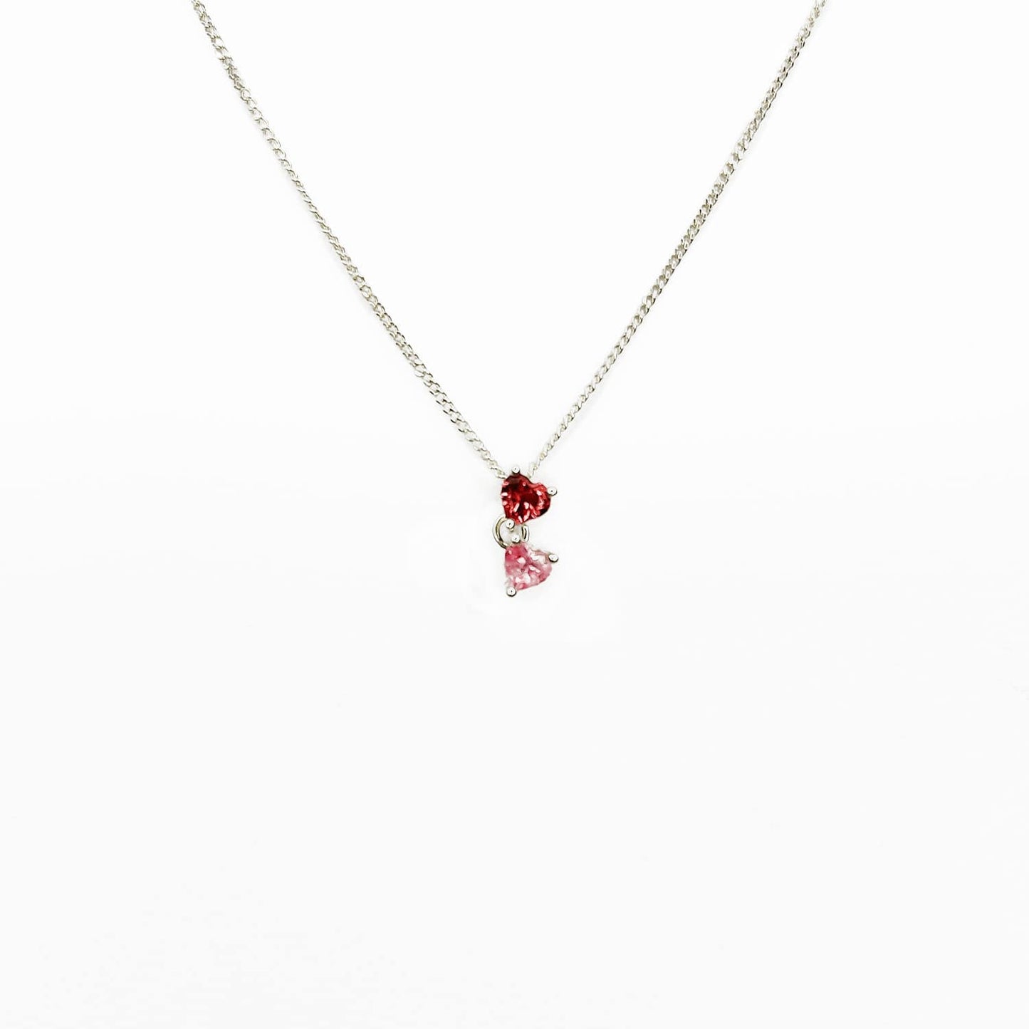 Enhance your style with our Double Heart necklace featuring two interlinked heart-shaped pink gemstones. Crafted with love and passion, this Sterling Silver slider pendant symbolizes unbreakable bonds and adds a touch of elegance to any outfit. Perfect for expressing self-love or sharing with a loved one. Get yours today and add a mermazing touch to your everyday look!