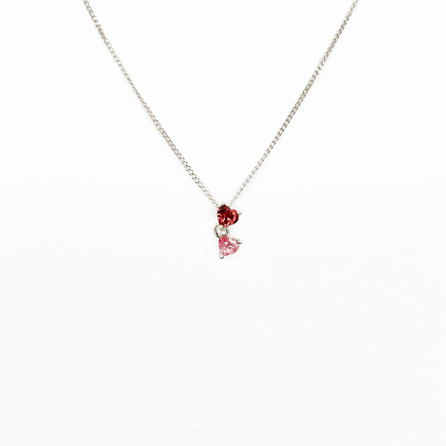 Enhance your style with our Double Heart necklace featuring two interlinked heart-shaped pink gemstones. Crafted with love and passion, this Sterling Silver slider pendant symbolizes unbreakable bonds and adds a touch of elegance to any outfit. Perfect for expressing self-love or sharing with a loved one. Get yours today and add a mermazing touch to your everyday look!