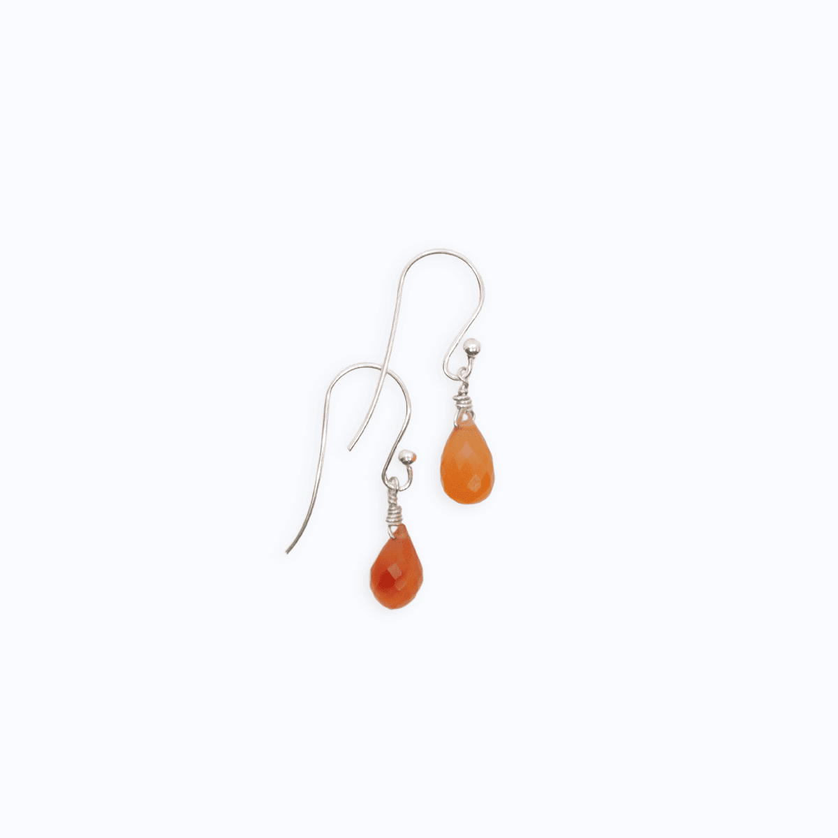 Flat lay view of two Sterling Silver shepherd’s hook earrings with Carnelian drop on white background.