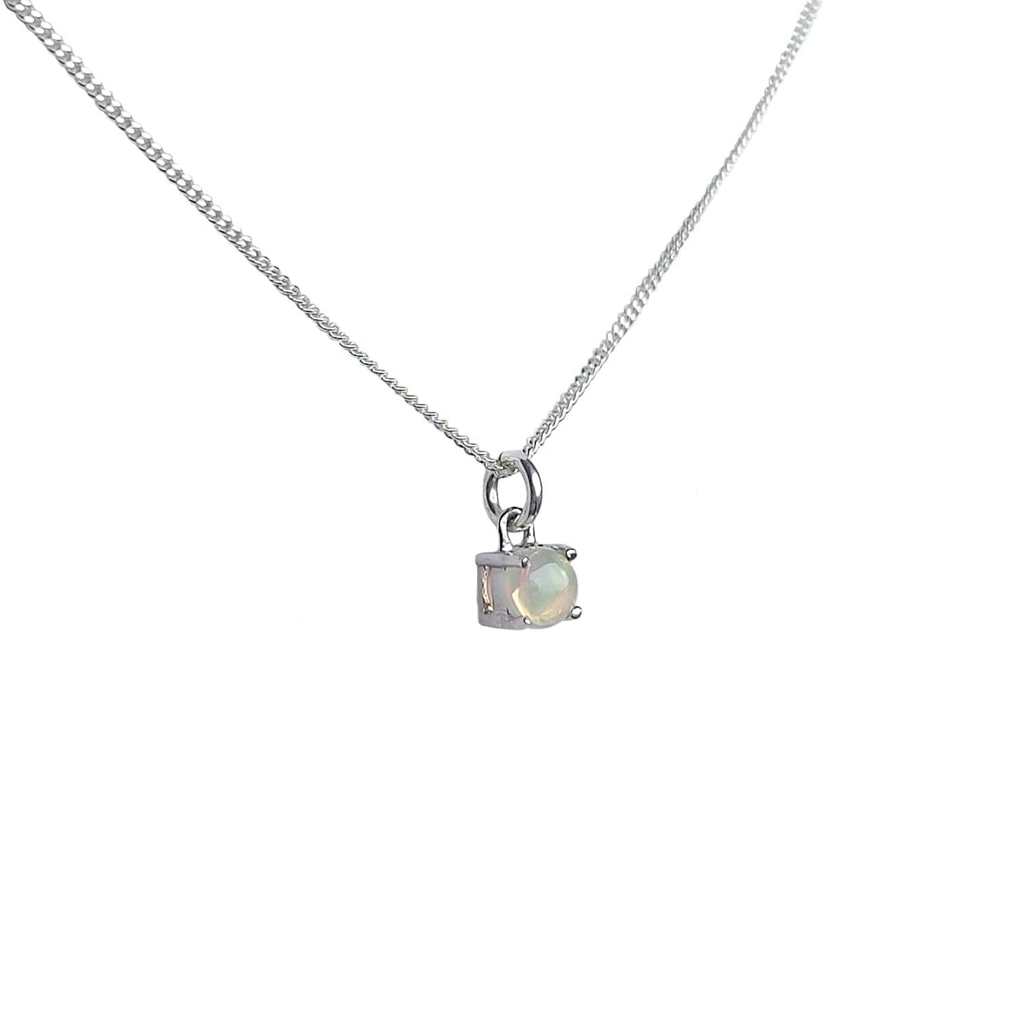 Side view of Ethiopian Opal Pendant necklace on white background. Features 5mm round Ethiopian Opal gemstone set in four claws.