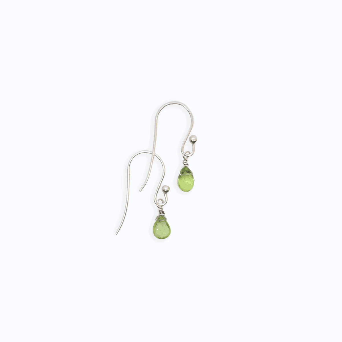 Flat lay view of two Sterling Silver shepherd’s hook earrings with Peridot drop on white background.