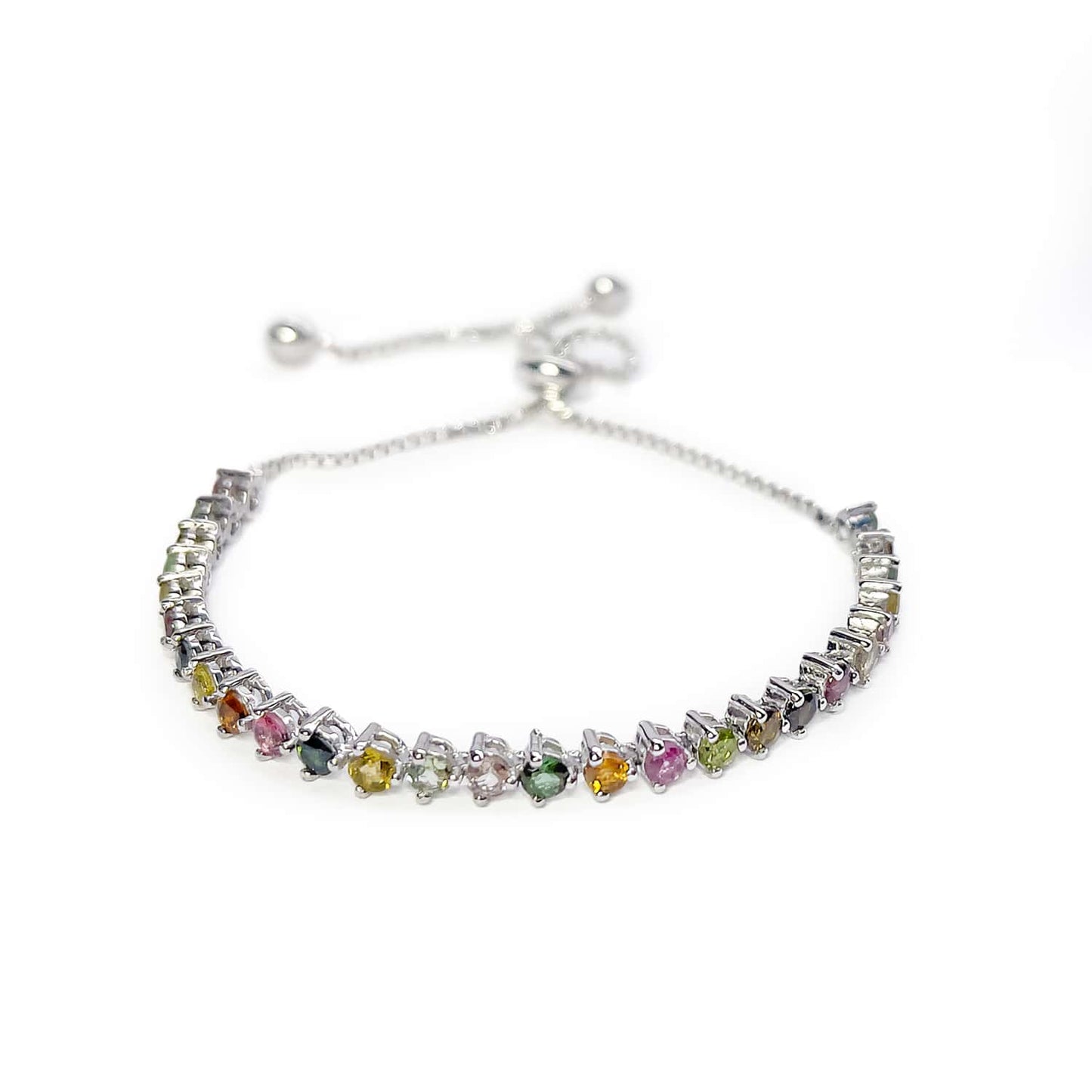 Slight top view of Sterling Silver Tennis Bracelet on white background. Features 30 Round Brilliant Cut Multicoloured Tourmaline gemstones.