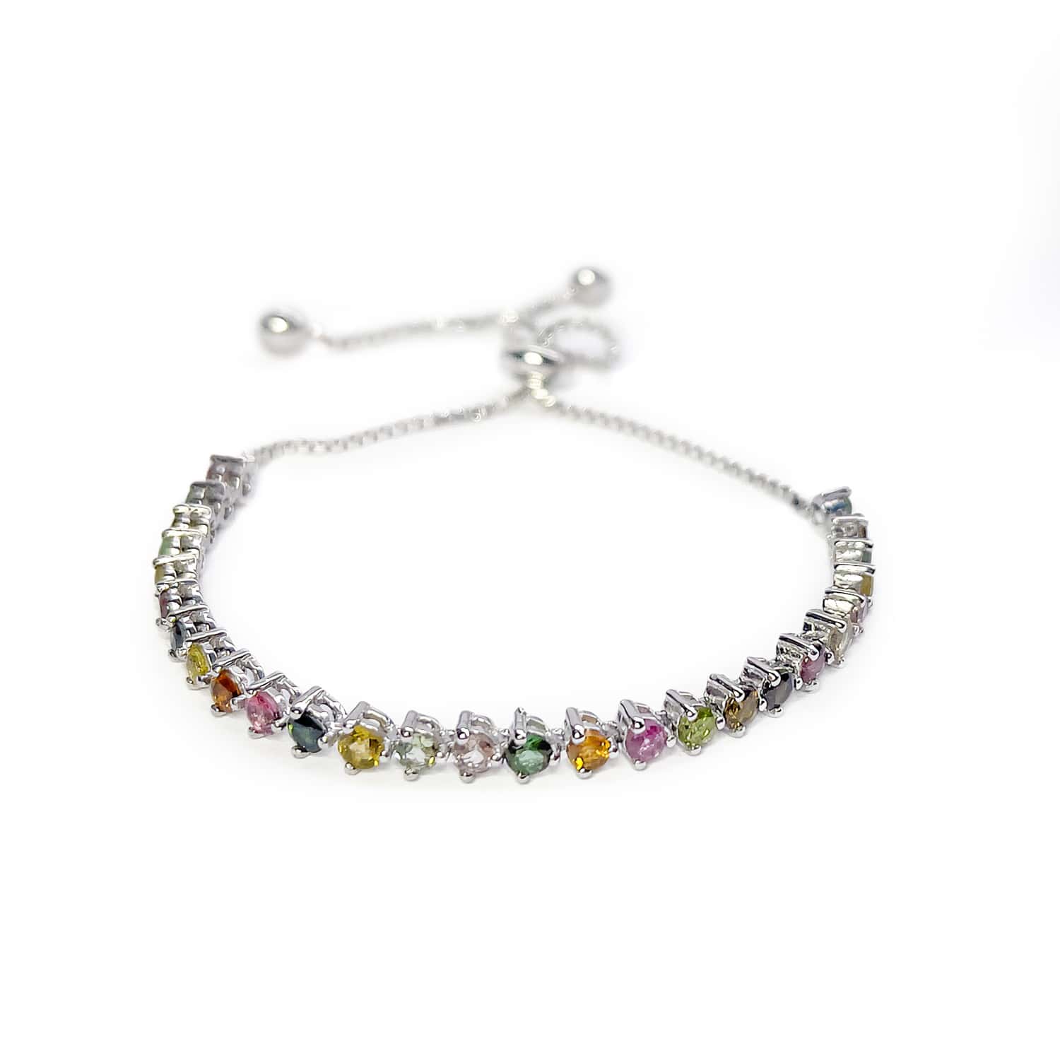 Slight top view of Sterling Silver Tennis Bracelet on white background. Features 30 Round Brilliant Cut Multicoloured Tourmaline gemstones.