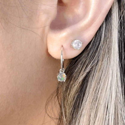 Side view of a woman wearing Moonstone Dangle Hoop earring together with Moonstone Stud earring, showcasing a detachable 5mm round Moonstone gemstone set in four claws on a Sterling Silver hoop.