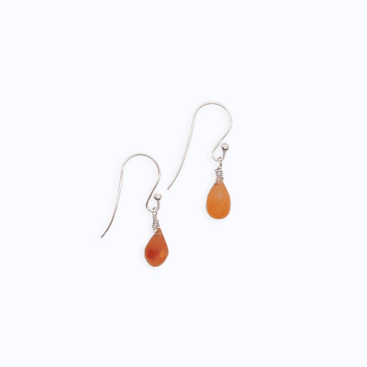 Flat lay view of two Sterling Silver shepherd’s hook earrings with Carnelian drop on white background.