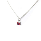 Close-up view of the Garnet Pendant Sterling Silver necklace on a white background. The necklace features a 5mm round Garnet gemstone set in four claws on a 45cm curb chain.