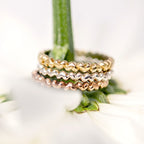 A Sterling Silver heart-shaped ring with multiple interlocking hearts forming a band, available in silver, yellow gold, and rose gold options