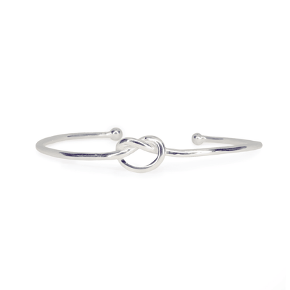 Front view of Love Knot Bangle ring on white background. Sterling Silver wire cuff with centre knot, approximately 2.4mm thick.