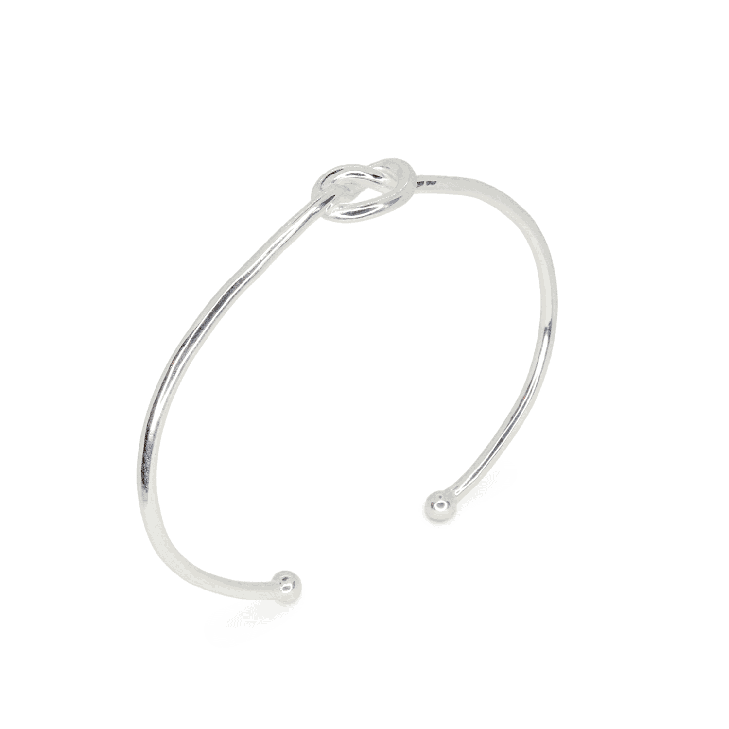 Slight top side angle of Love Knot Bangle ring on white background. Sterling Silver wire cuff with centre knot, approximately 2.4mm thick.