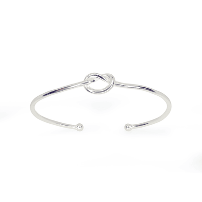 Top view of Love Knot Bangle ring on white background. Sterling Silver wire cuff with centre knot, approximately 2.4mm thick.