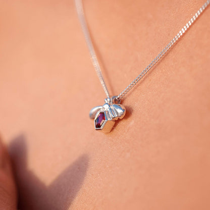 Close-up side view of the Bee-YOU-tiful Bee Pink Tourmaline Bling around a woman's neck, featuring a 45cm curb chain and a Sterling Silver pendant with a bee and a 4mm hexagonal Pink Tourmaline set in its belly.