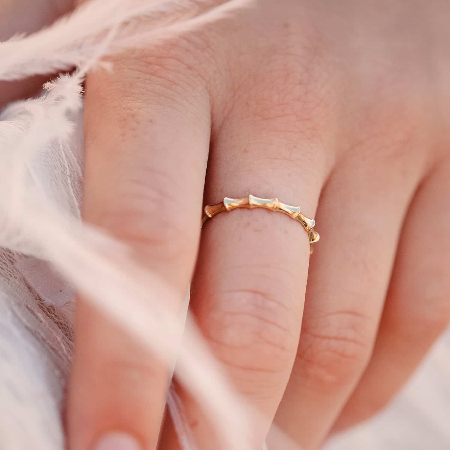 Front view of woman's hand adorned with Bamboo ring, showcasing 2.5mm wide Sterling Silver band and Bamboo-inspired design, ideal for stacking.