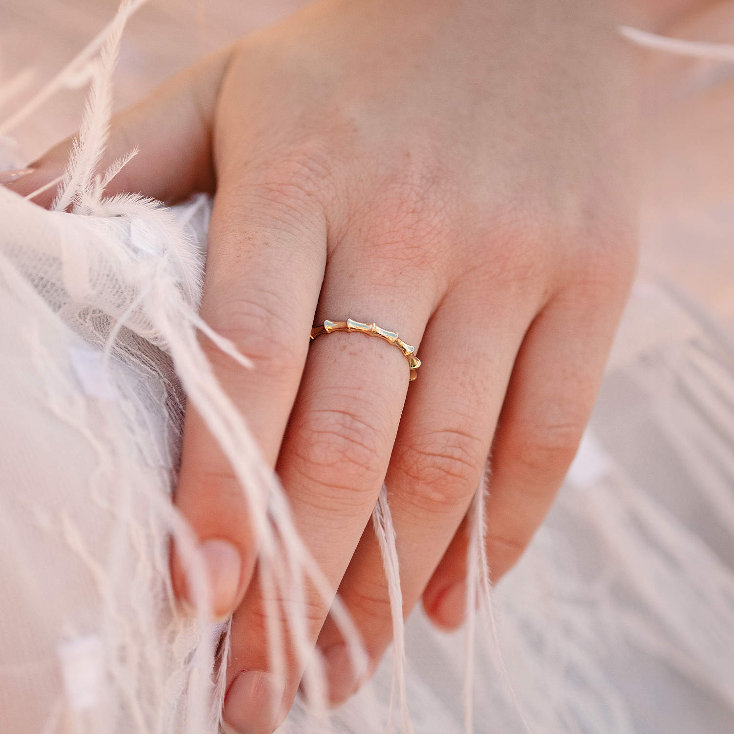 Front view of woman's hand adorned with Bamboo ring, showcasing 2.5mm wide Sterling Silver Yellow Gold plated band and Bamboo-inspired design, ideal for stacking.